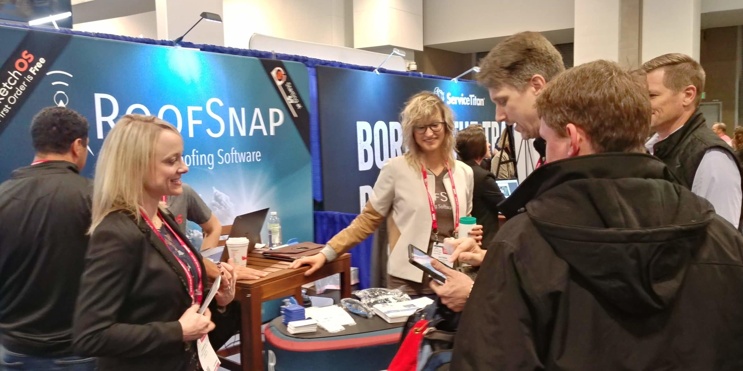 Jen and Katrina greet contractors at the RoofSnap Booth
