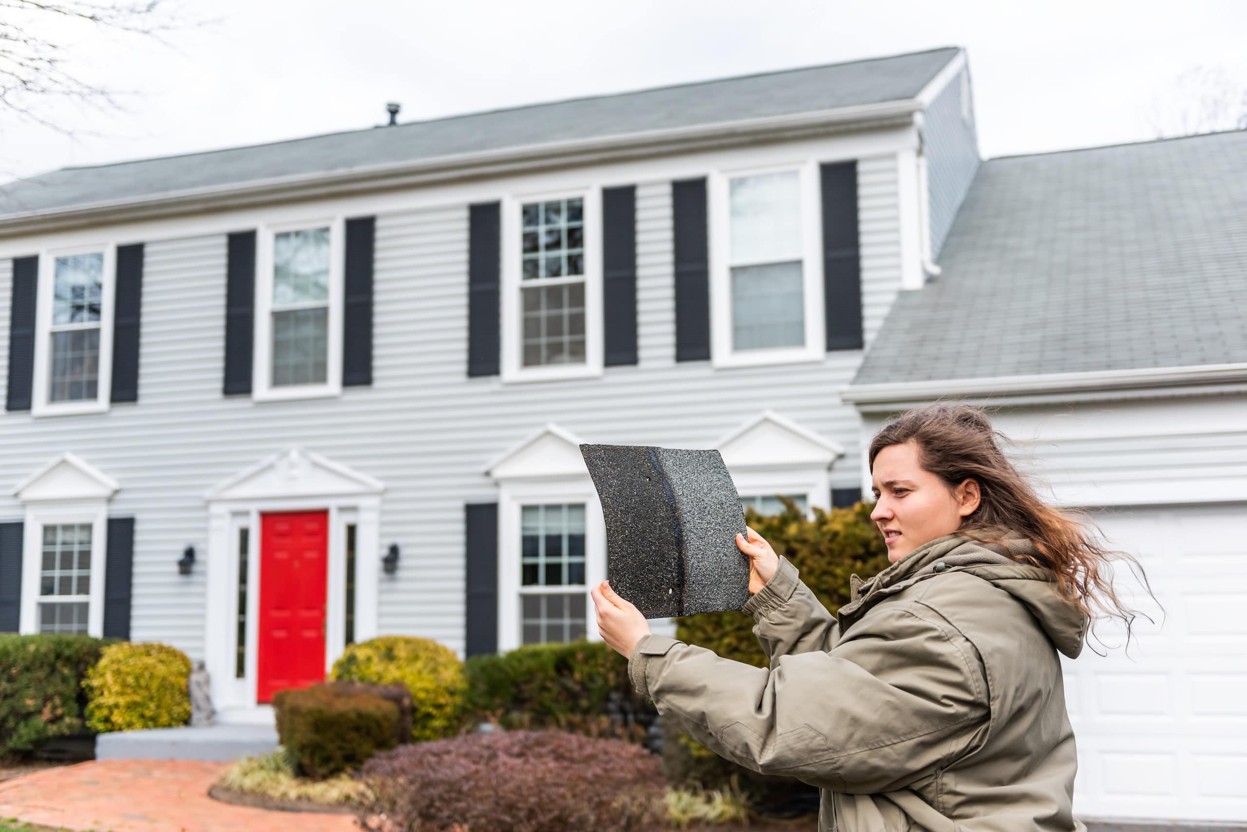 A homeowner compares shingles.