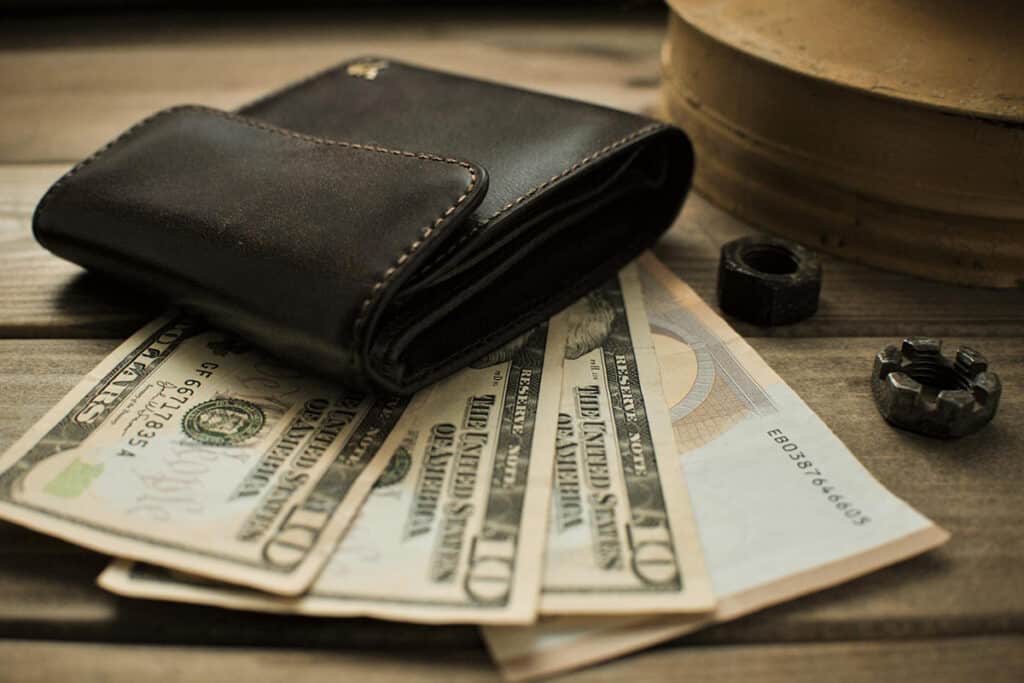 Wallet with cash, symbolizing the average pay for roofers and their potential earnings.