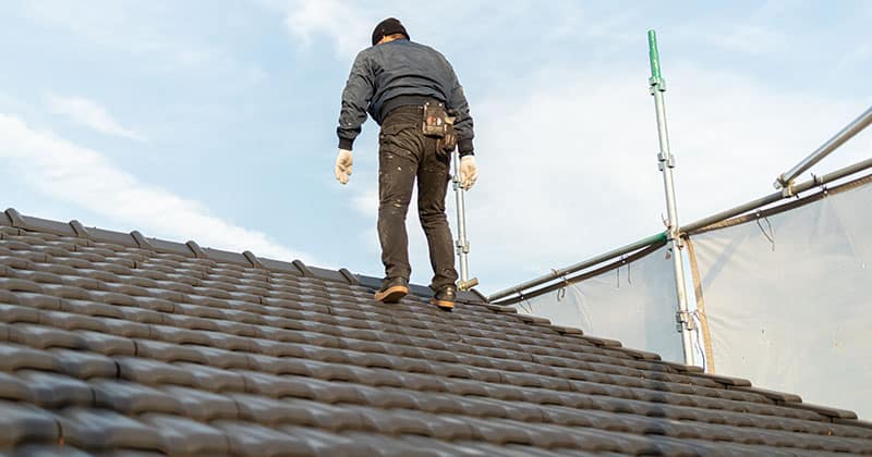Roofer standing on new roof